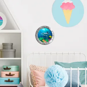 Detail shot of a 3D porthole wall sticker featuring ocean animals like dolphins.