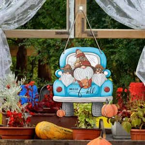 Detail view of Thanksgiving wooden truck and gnome hanging sign with fall garden decor.