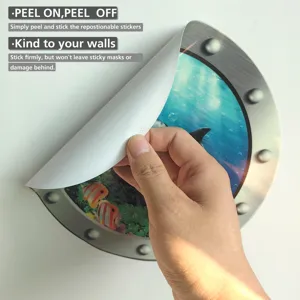Close-up detail shot of the removable marine porthole wall sticker being peeled by hand.