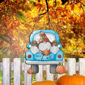 Thanksgiving wooden hanging sign detail, blue truck with cute gnomes and fall decor.