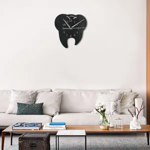 Detail scene showing a creative tooth-shaped wall clock hanging on the clean white living room wall.