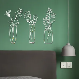 Close up view of 3D acrylic mirror flower vase wall stickers installed on green wall for decor.