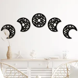Detailed view of black wooden hollowed moon phase wall hanging art for home interior decor.