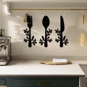 Détail de décoration murale en bois avec formes de fourchette, cuillère et couteau et feuilles.