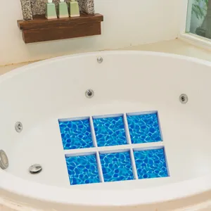 Detail view of blue water pattern non slip bathtub stickers applied on white tub bottom.