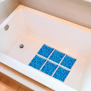 Detailed view of blue water ripple anti-slip bathtub stickers installed inside clean white tub.