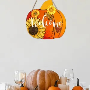 Wooden pumpkin hanging sign detail featuring sunflower print and welcome text for autumn decor