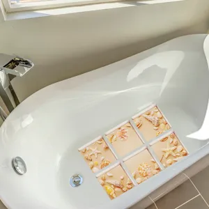 Detailed view of ocean seashell pattern anti-slip bathtub stickers placed in a white tub.