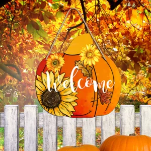 Detail view of autumn pumpkin wooden hanging sign with sunflower and welcome text for decor.