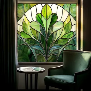 Stained glass window film detail showing green art nouveau leaf pattern in interior room.