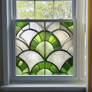 Decorative window film detail showing green and white art deco fan pattern glass sticker.