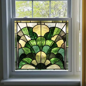 Detailed view of stained glass window film featuring elegant art deco fan pattern in green.