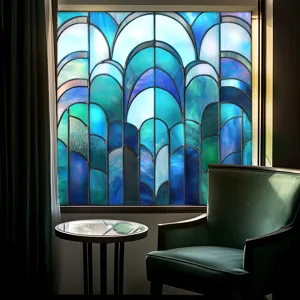 Stained glass window film detail showing blue art deco geometric pattern on window glass.