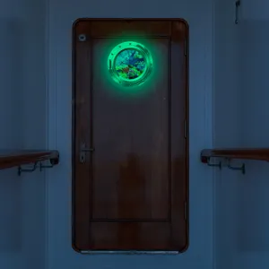 Detailed view of the luminous porthole wall sticker featuring marine animals in the dark.