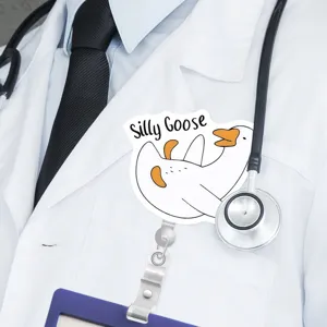 Close-up detail of the funny goose badge reel clip, showing clear print on white lab coat.