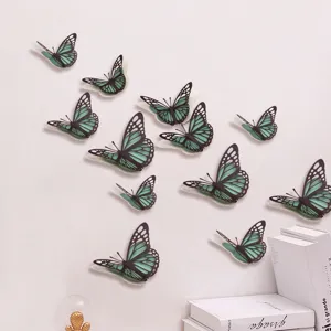 Gedetailleerd overzicht van 3D holle parelpapier vlinder muurstickers, groene DIY wanddecoratie.