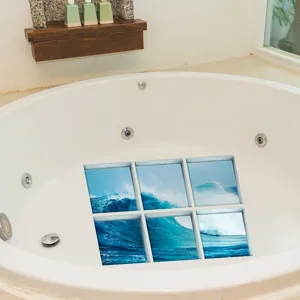 Detailed view of ocean wave pattern anti-slip bathtub stickers applied securely in a white tub.
