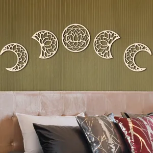 Wood moon phase wall hanging detail showing delicate hollow lotus design above bed headboard.
