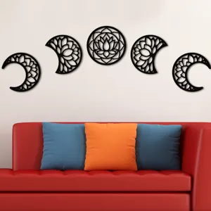 Detailed view of wooden moon phase wall art hanging above a modern living room sofa.