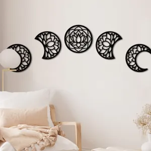 Detailed view of black wooden moon phase wall art hanging in a cozy living room decor.
