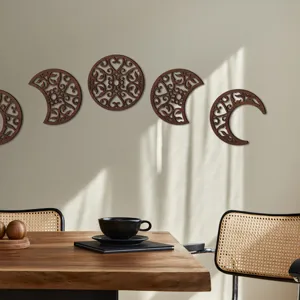 Detailed close-up view of wooden hollowed out moon phase wall art hanging set in room