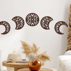Detail shot of wooden moon phase wall hanging decor, highlighting exquisite hollow wood carving.