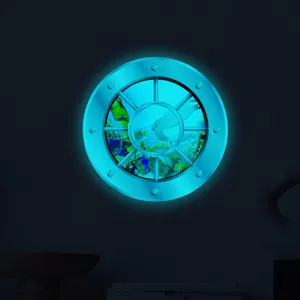 Luminous porthole wall sticker detail showing underwater world with glowing effect in dark room.