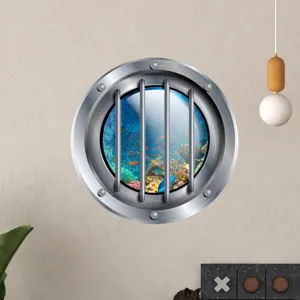 Close-up detail of the luminous porthole wall sticker showcasing underwater coral reef and fish.