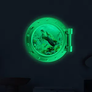 Glow in the dark porthole wall sticker featuring sea turtle underwater scene for kids room.