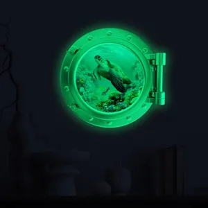 Luminous porthole wall sticker, glowing underwater turtle decor for kids room and nursery.