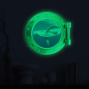 Glow in the dark whale porthole wall sticker, neon green luminous kids room decor detail.