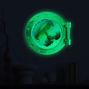Luminous porthole wall sticker featuring glowing jellyfish and fish, perfect for kids room decor.