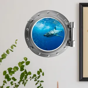 Close-up detail of a 3D porthole wall sticker featuring an underwater shark scene on a wall.