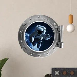 Glow-in-the-dark 3D space astronaut porthole wall sticker detail for kids room decoration.
