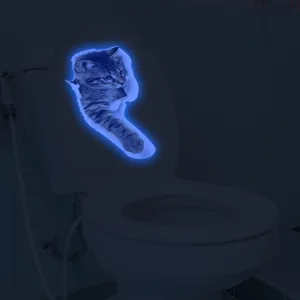 Luminous 3D cat toilet sticker, glowing fluorescent wall decal for bathroom decor.