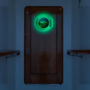 Detailed view of luminous porthole wall sticker, glowing marine turtle fake window scene.
