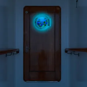 Detailed scene of glowing marine porthole wall sticker showing underwater fish design.