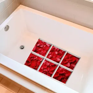 Close up of red rose petal anti-slip bathtub stickers detail showing textured surface inside tub.