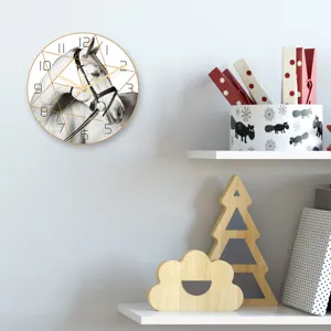 Detail view of modern minimalist horse head wall clock with geometric golden lines and clear dial.