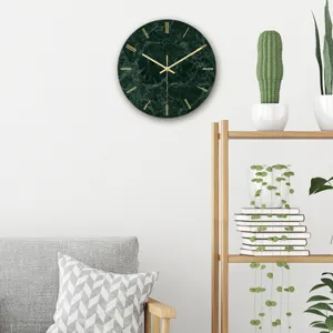 Detailed view of the modern green marble wall clock with gold hands for elegant living room decor.