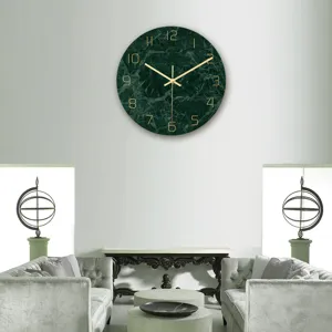 Detailed view of modern green marble wall clock with luxury gold numbers in elegant living room.