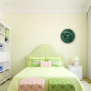 Detail shot of the dark green marble wall clock in a modern bedroom decor setting.