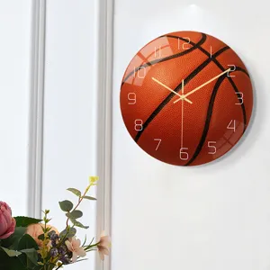Detailed view of basketball wall clock showing acrylic texture, silent movement and gold hands.