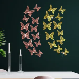 Metallic 3D hollow butterfly wall stickers set, elegant home decor detail for living room.