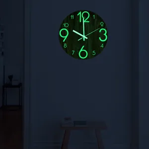 Detailed view of the luminous wall clock glowing green in the dark, highlighting night light.