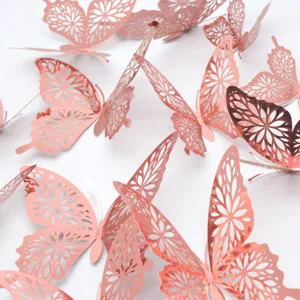 Detailed close-up of metallic rose gold hollow 3D butterfly wall stickers for decor.