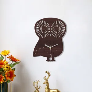 Detailed view of a creative wooden owl wall clock hanging on a clean white wall decor.