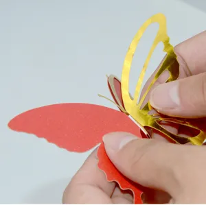 Close-up detail showing double layer 3D hollow butterfly wall sticker assembly process.