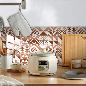 Detailed view of modern kitchen ceramic slow cooker with geometric tile wall sticker backdrop.