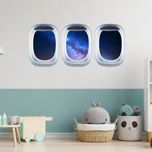 Scène de sticker mural pour enfants avec trois hublots d'avion et vue galaxie étoilée.